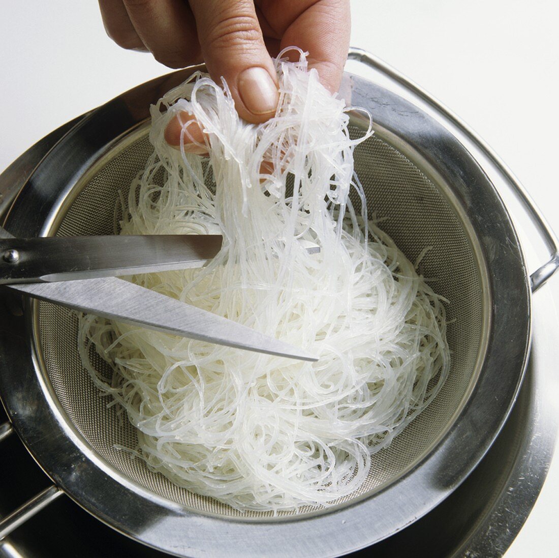 Cutting glass noodles with scissors