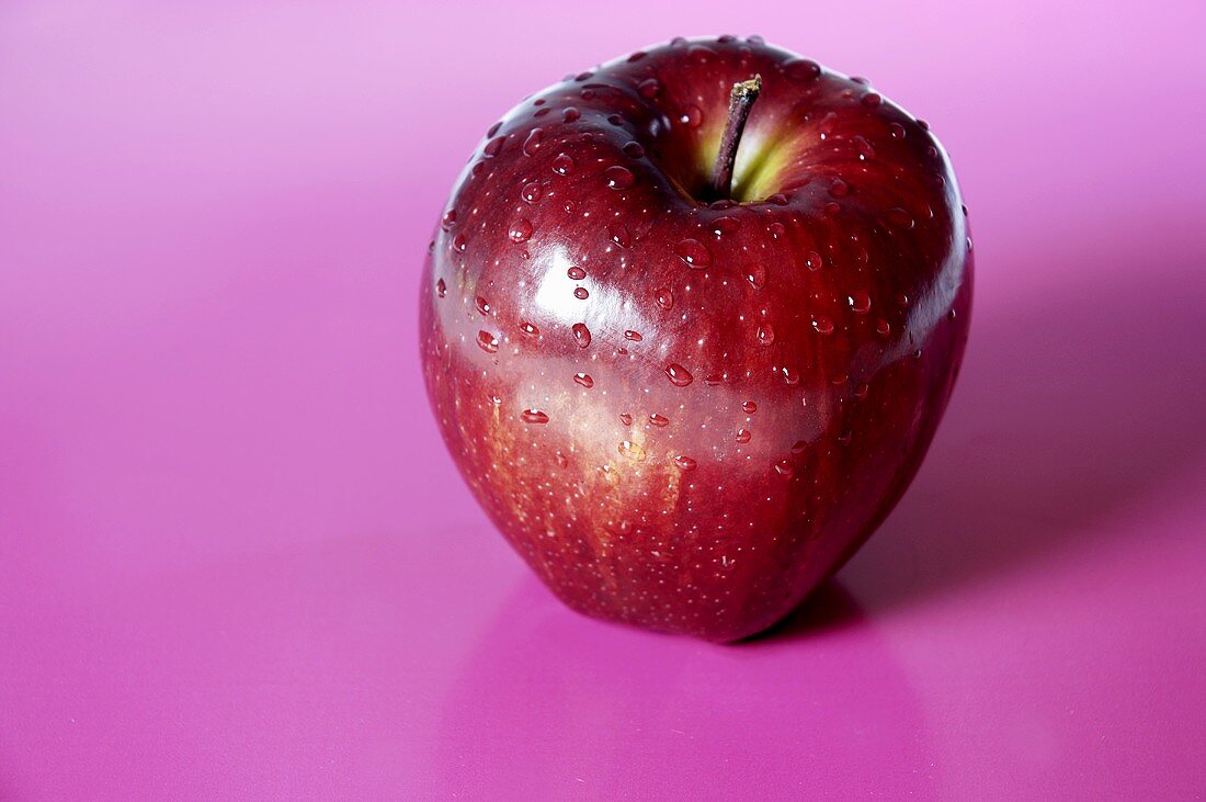 A red apple with drops of water