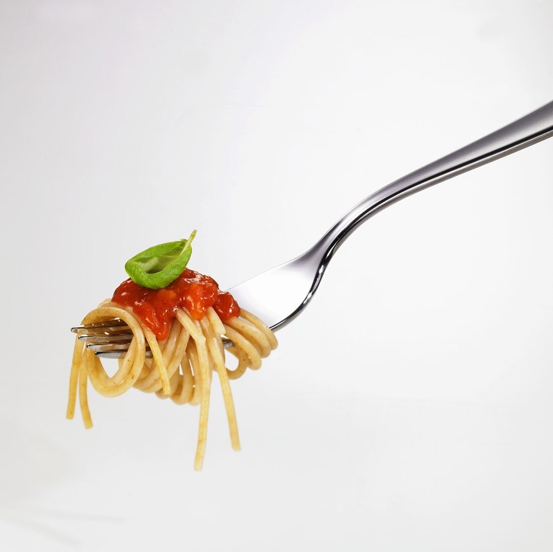 Spaghetti with tomato sauce on fork
