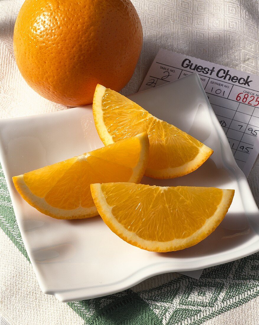 Fresh Orange Slices on Napkin on Dinner Check