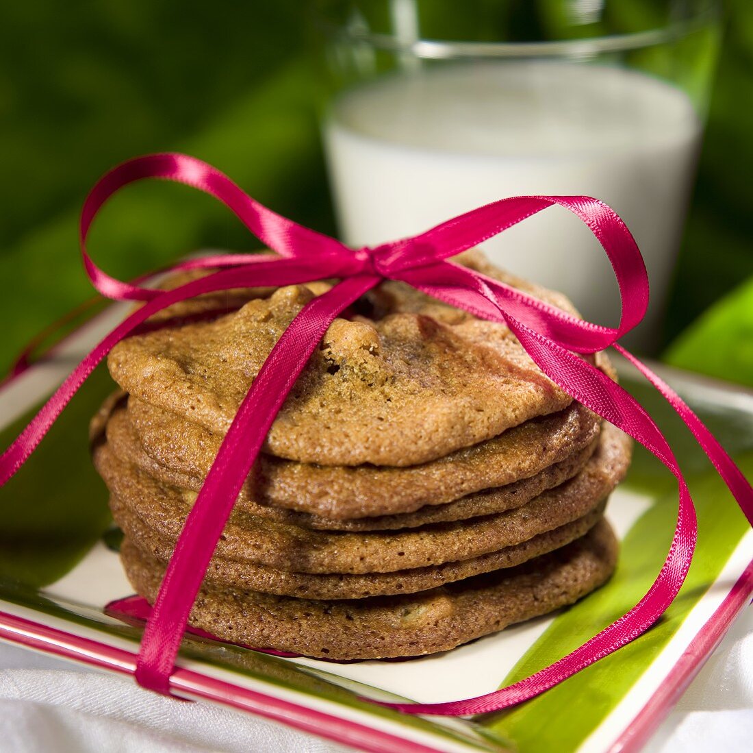 Stack of Cookies Tied with a Pink Ribbon; Glass of Milk