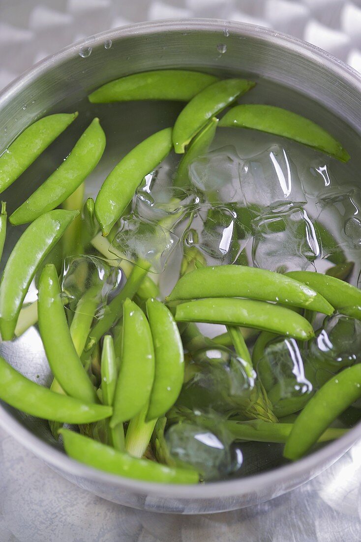 Sugar snap peas in iced water