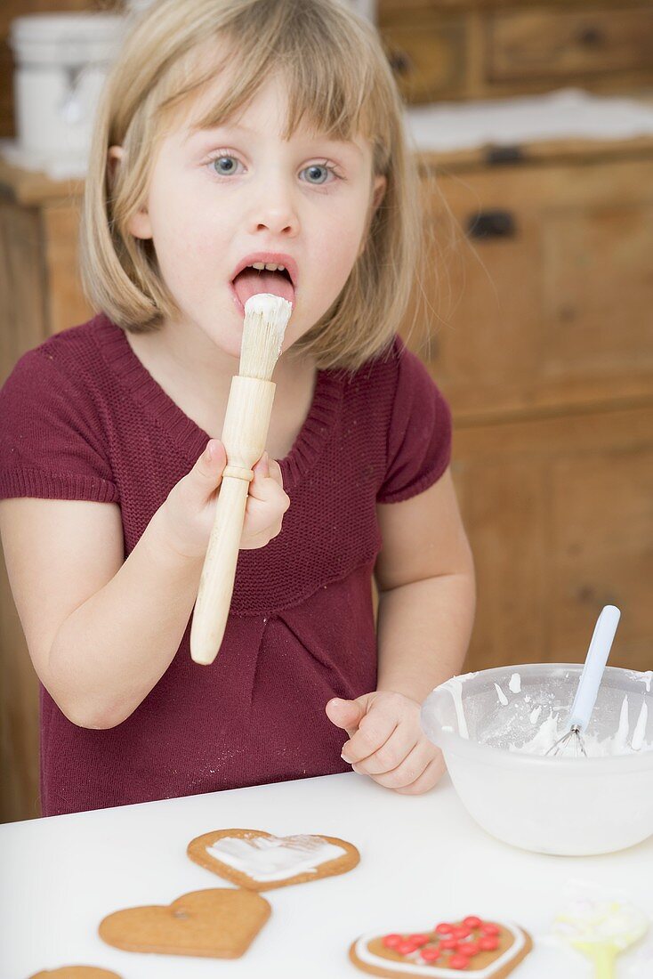 Little girl decorating biscuits