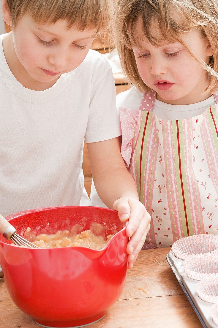 Boy and girl making muffin mixture