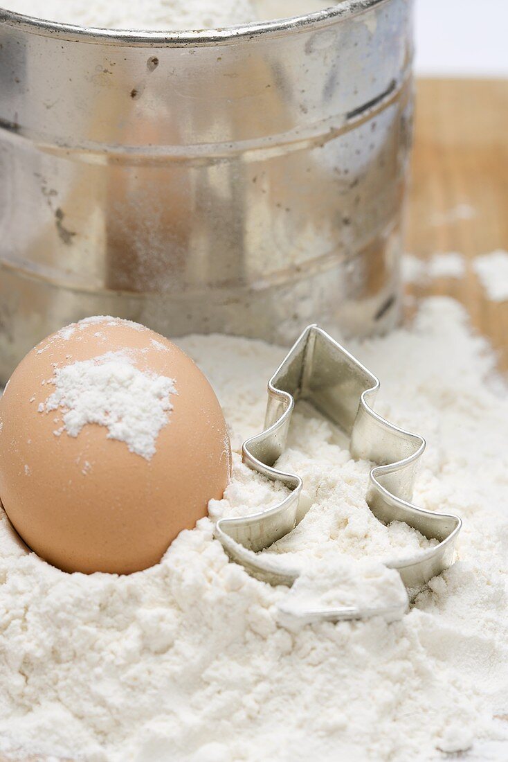 Egg, flour, flour sifter and cutter