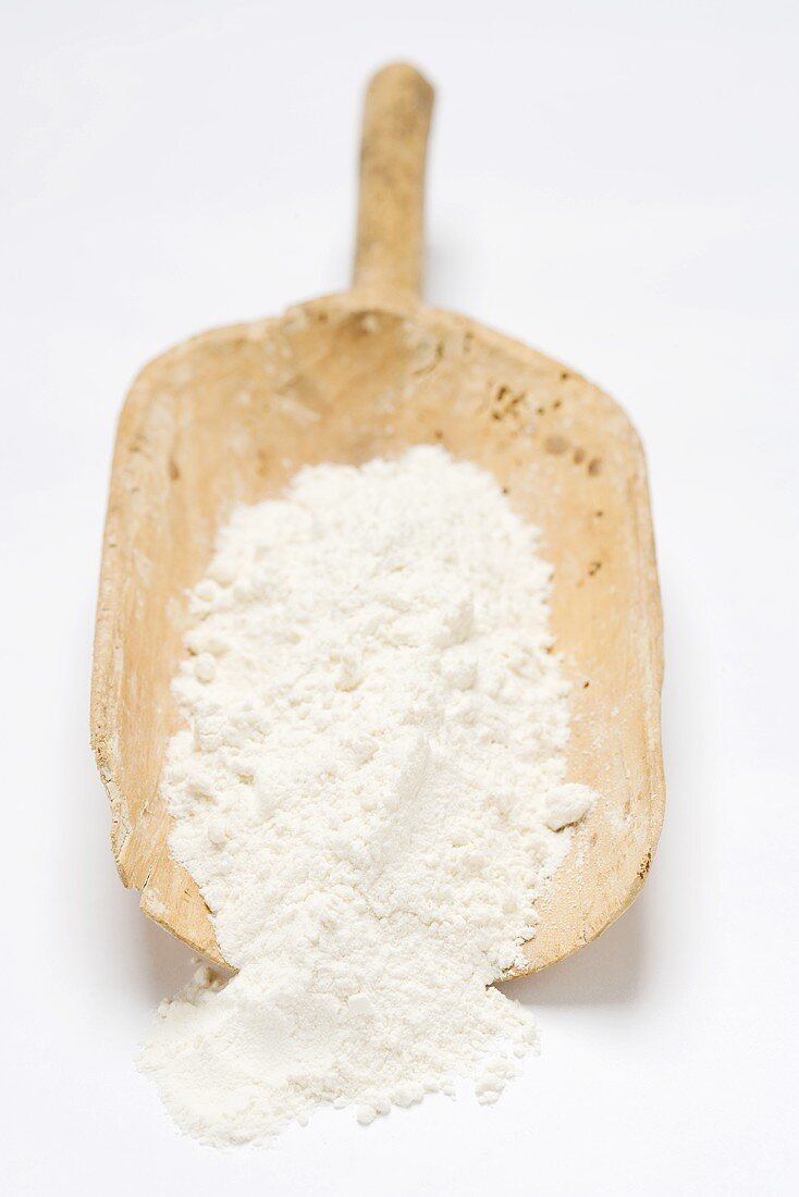 Flour in old wooden scoop