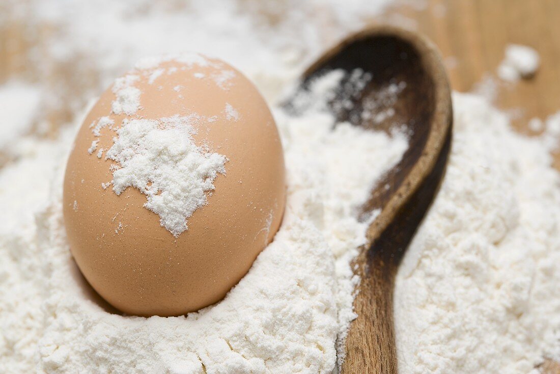 Egg in flour with wooden spoon