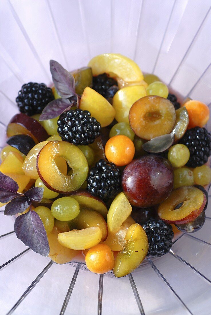 Fruit salad: plums, berries, grapes, physalis