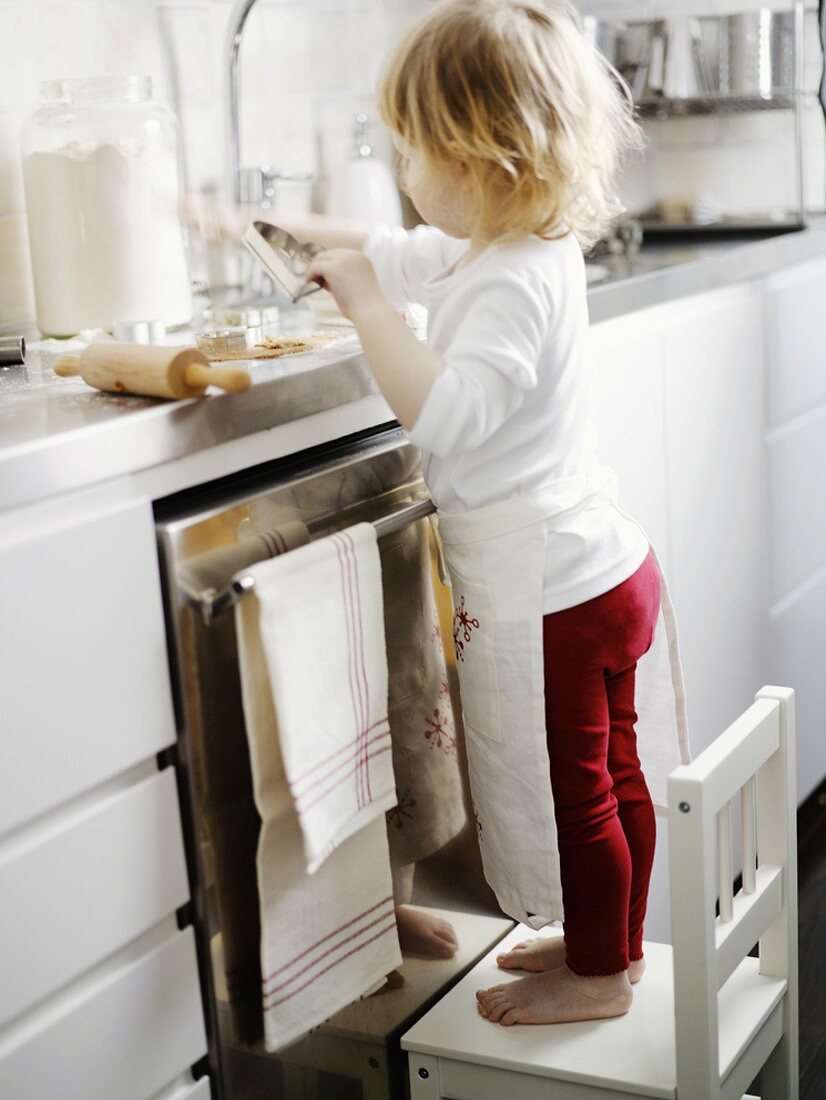 Little girl baking biscuits