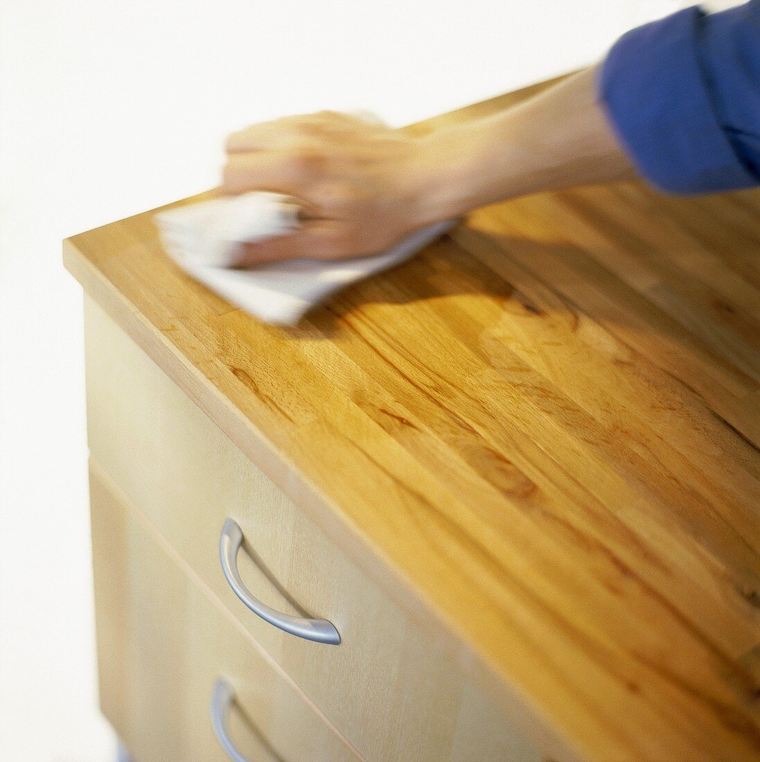 Dusting a chest of drawers