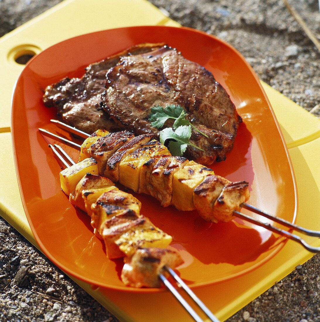 Grilled chicken and pineapple kebabs and pork neck
