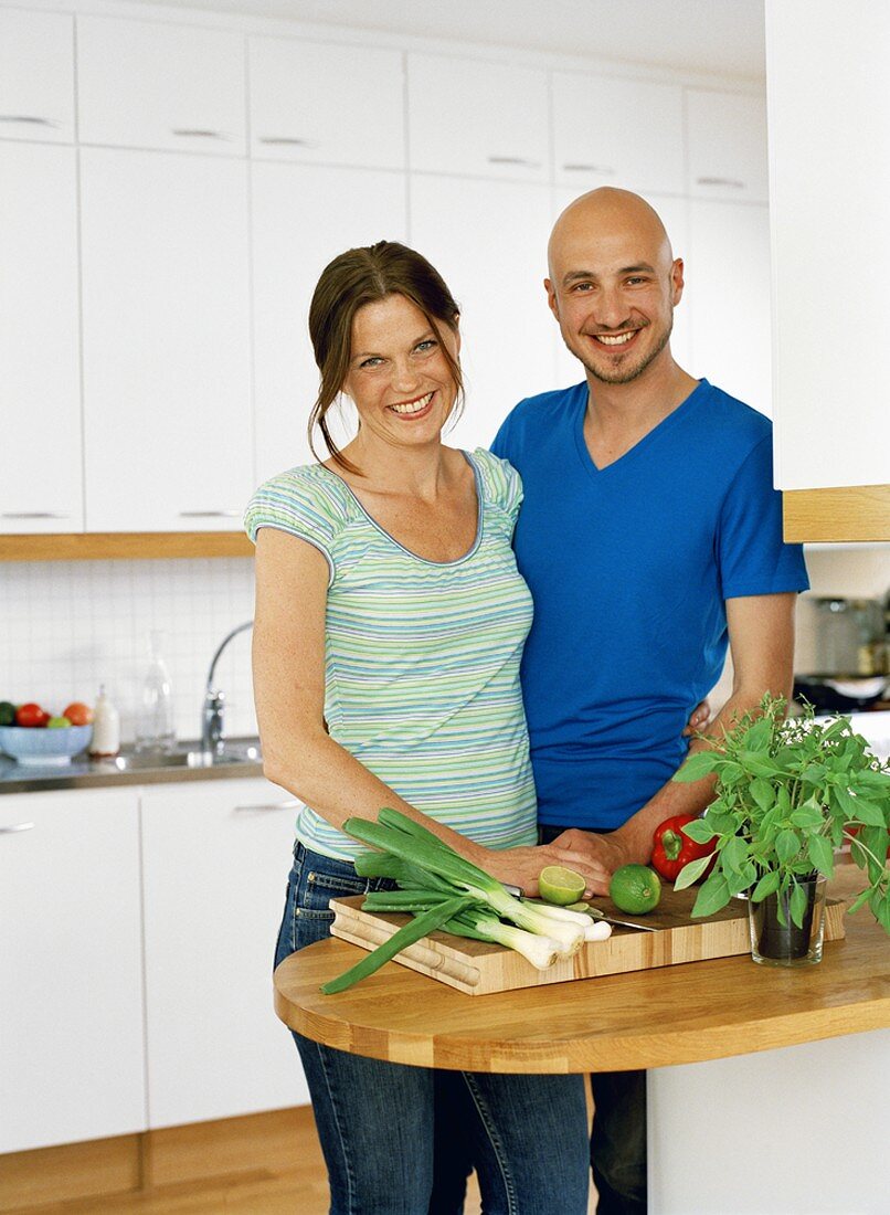 Man and woman standing in a kitchen