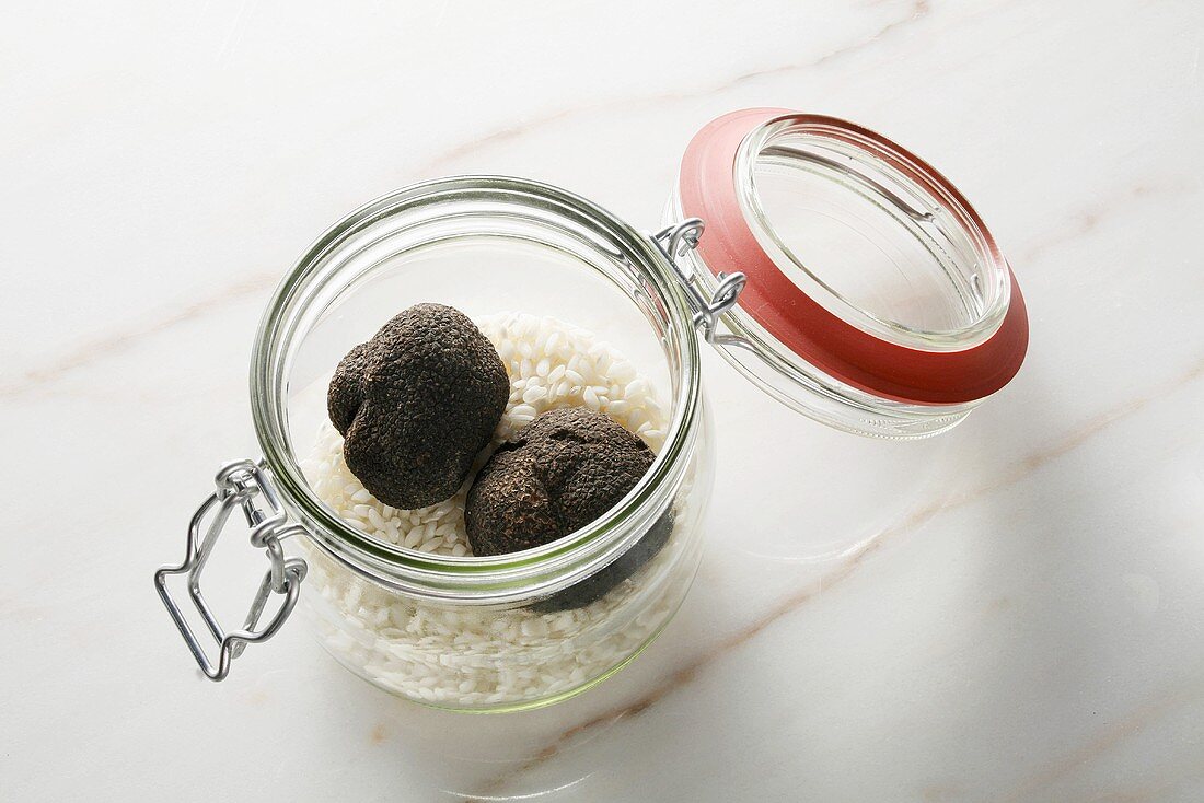 Black truffles and risotto rice in preserving jar