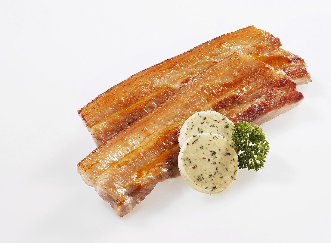 Fried slices of belly pork with herb butter