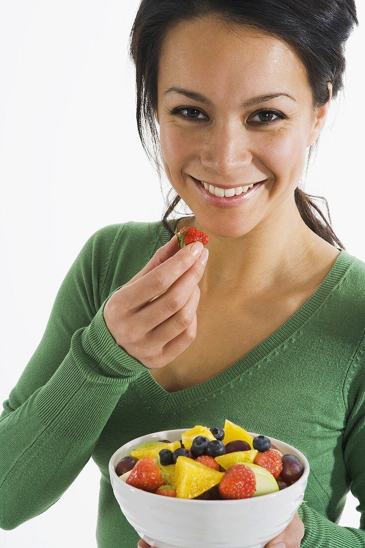 Woman eating fruit salad