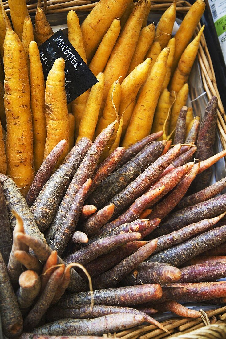 Different kinds of carrots in basket with label (Sweden)