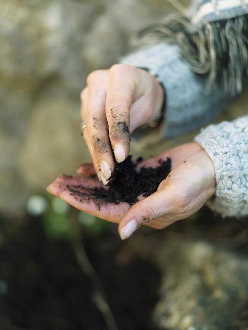 Woman with compost in her hands
