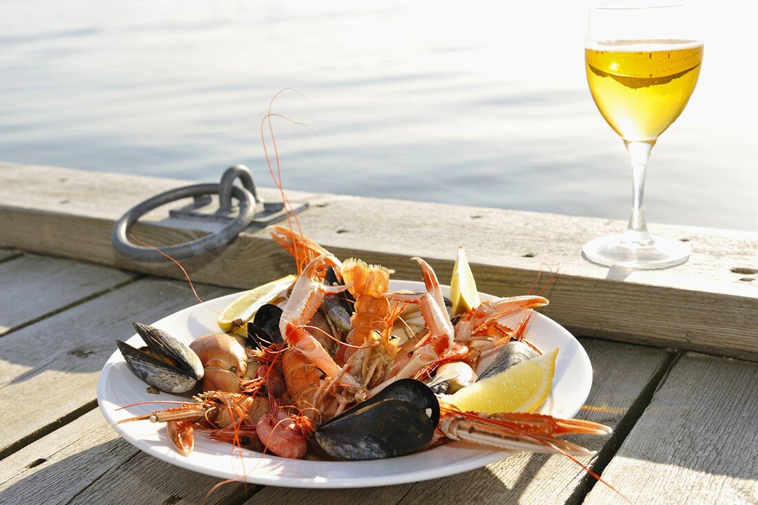Plate of seafood on landing stage by sea