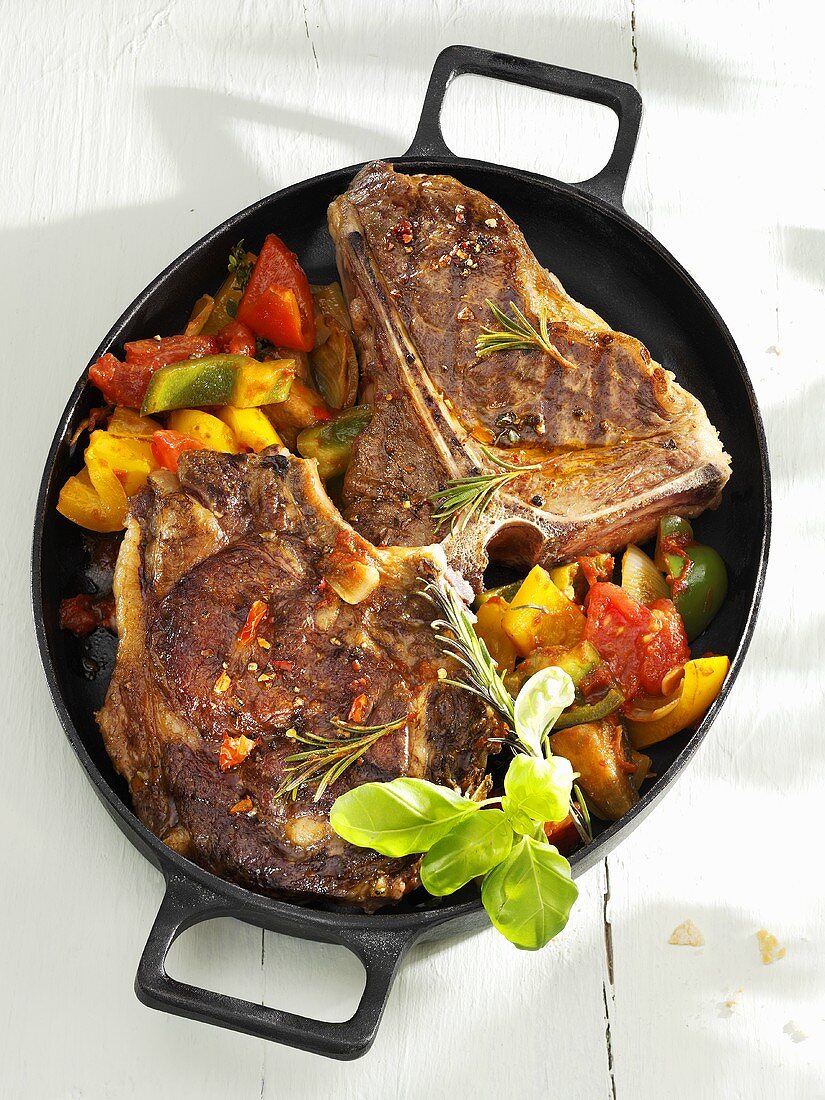 Grilled beefsteaks with ratatouille in cast-iron frying pan