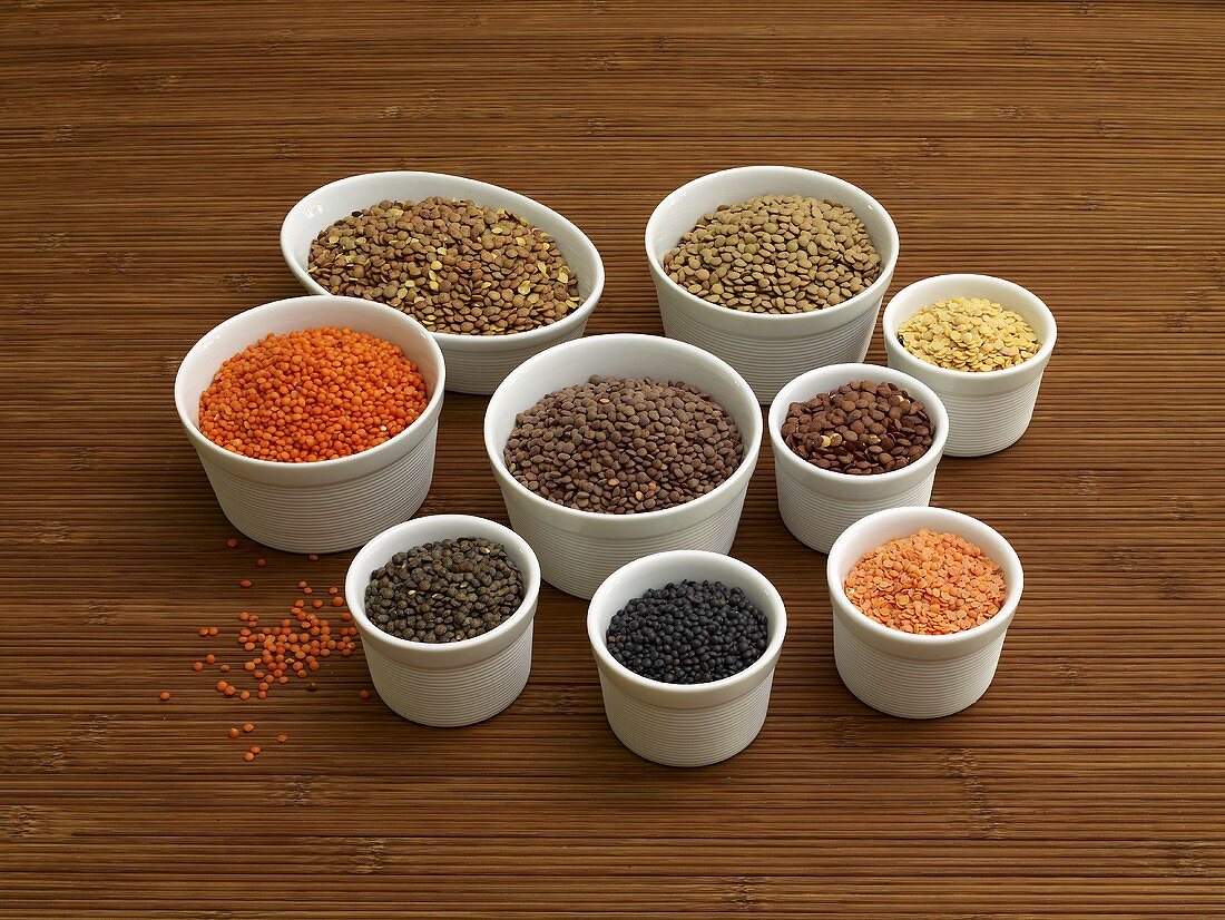 Various types of lentils in small bowls