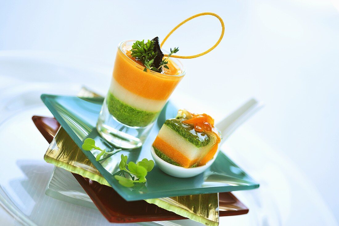 Vegetable terrine with salmon cream in glass and on spoon