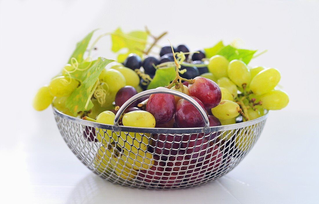 Various types of grapes in a metal basket