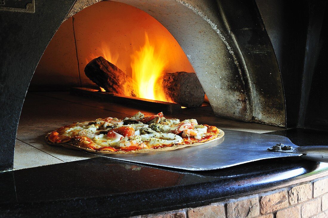 Seafood pizza in stone oven