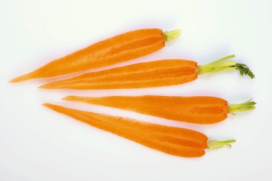 Four slices of carrot with tops