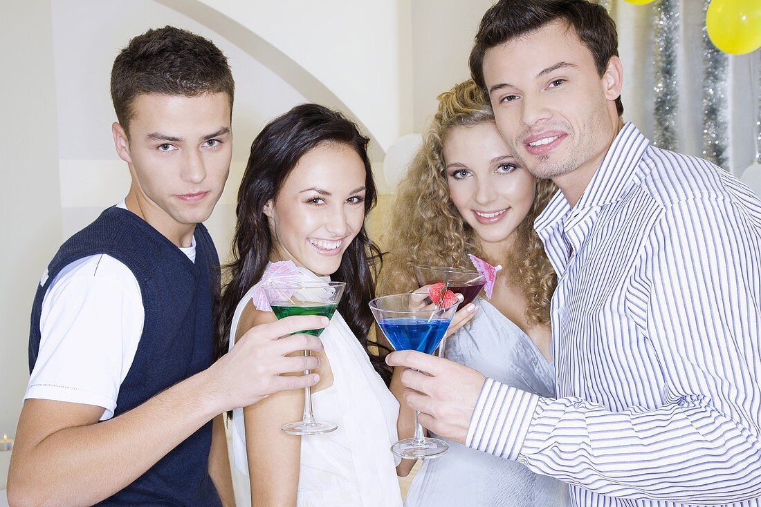 Young people drinking cocktails at a party