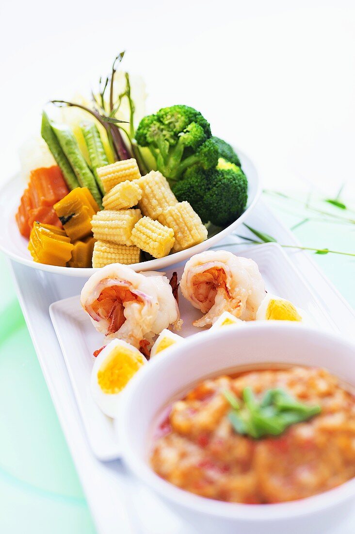 Assorted appetisers: prawns, vegetables, eggs and chilli dip