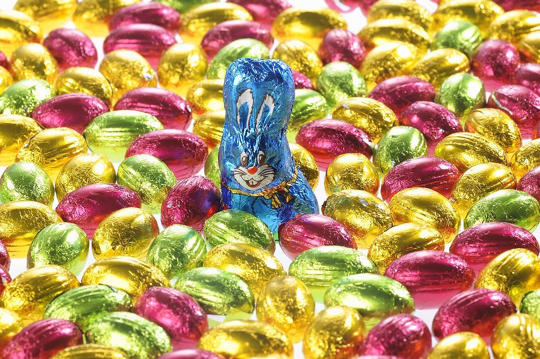 Small chocolate eggs in coloured foil, chocolate Easter Bunny
