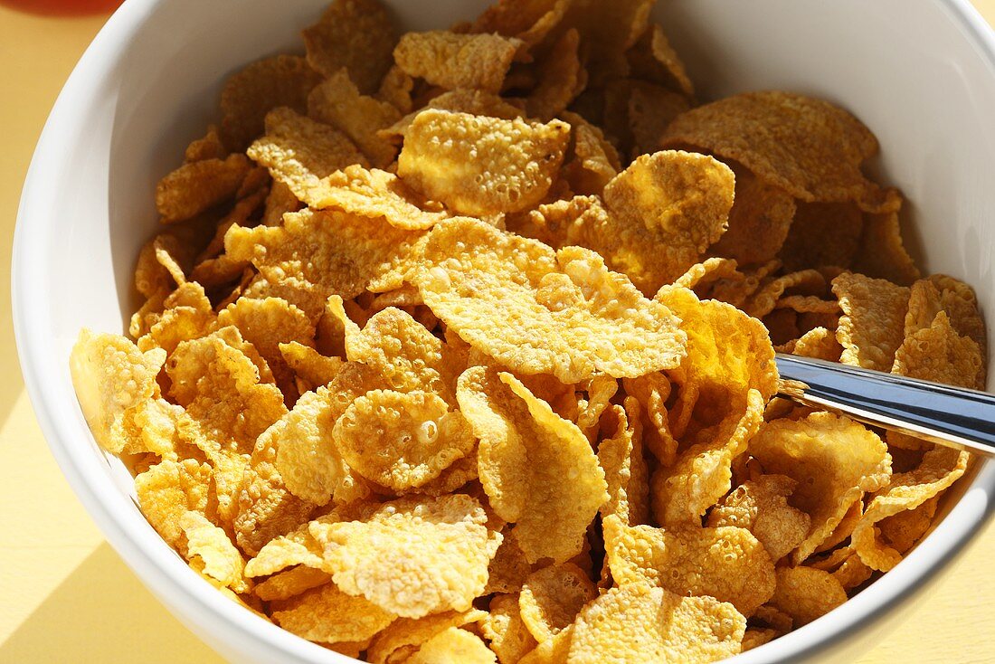 Cornflakes in bowl with spoon