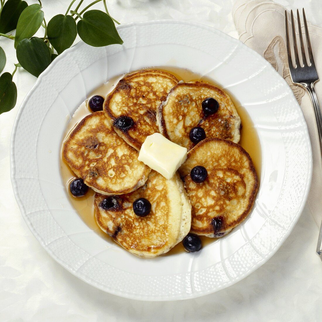 Plate of Blueberry Pancakes with Syrup and Butter