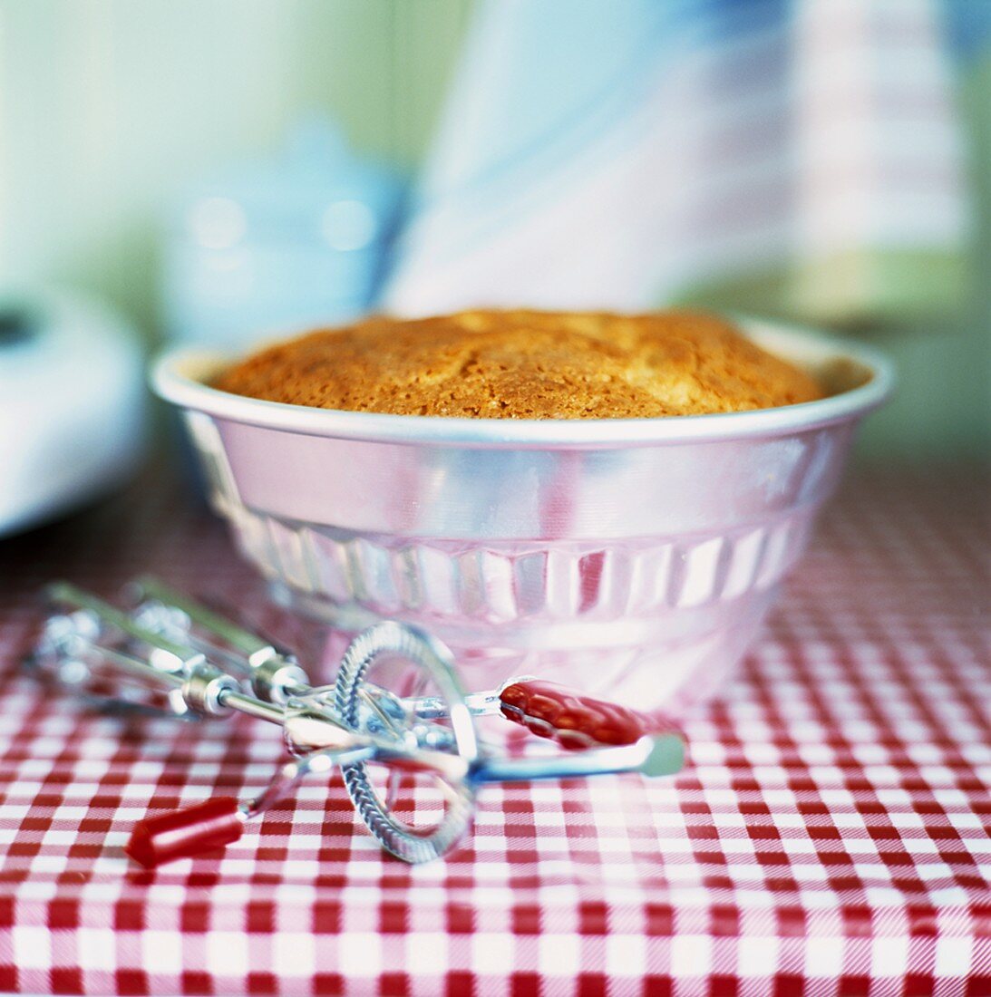 Ring cake in baking tin on kitchen table
