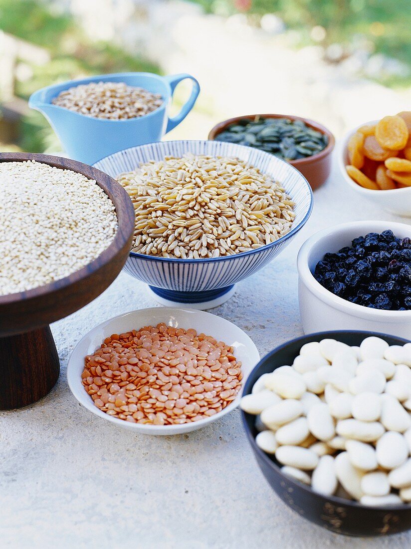 Assorted pulses and dried fruits in bowls