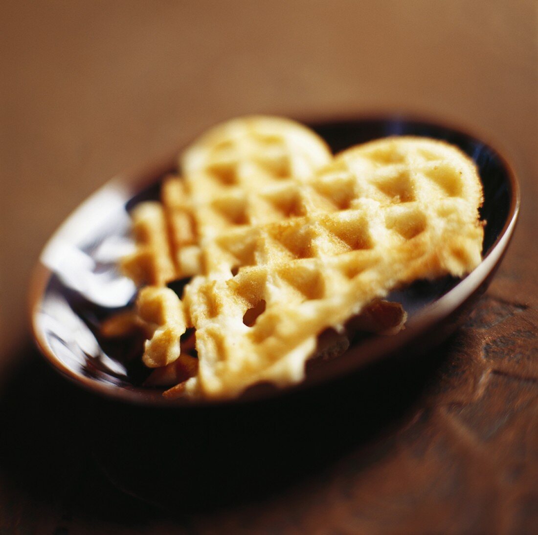 Heart-shaped waffle in brown dish