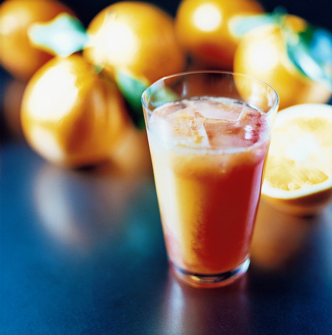 Campari Orange with ice cubes, oranges in background