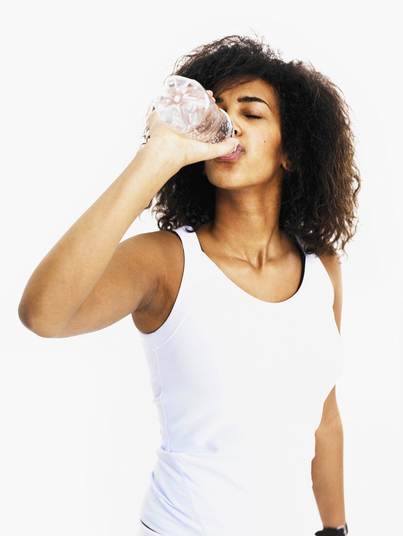 Woman drinking water out of bottle