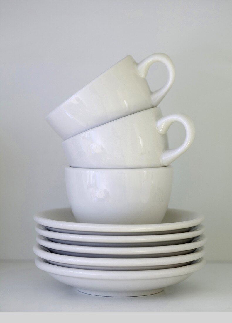 White coffee cups and saucers (stacked)