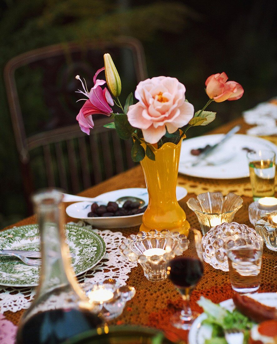 A table that has been set with wine, tee lights and flowers