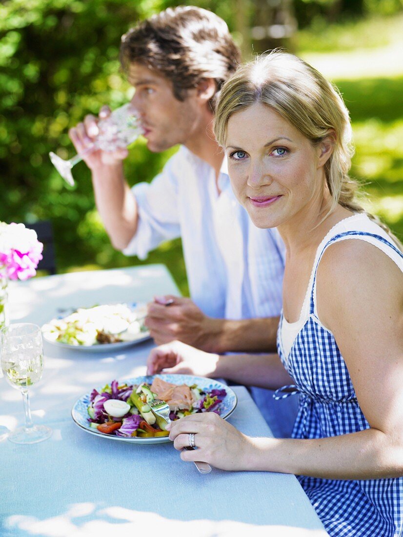 Couple eating in the garden in summer