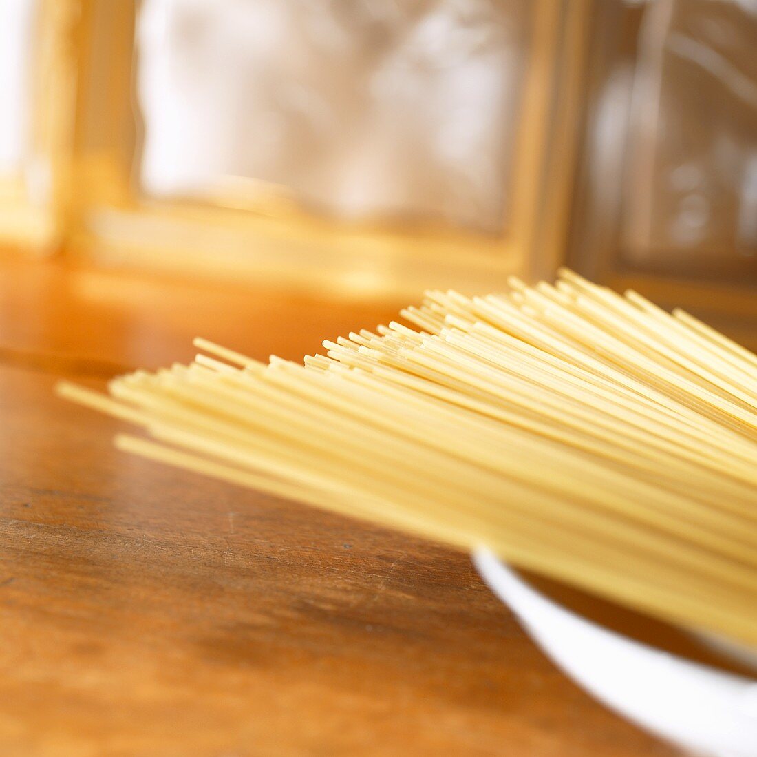 Uncooked spaghetti in a deep plate