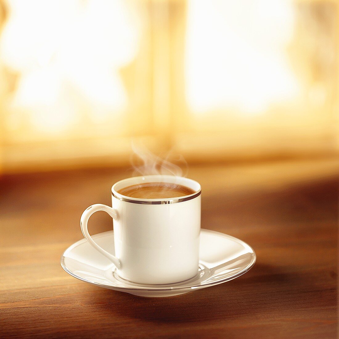 Coffee in silver-rimmed cup and saucer