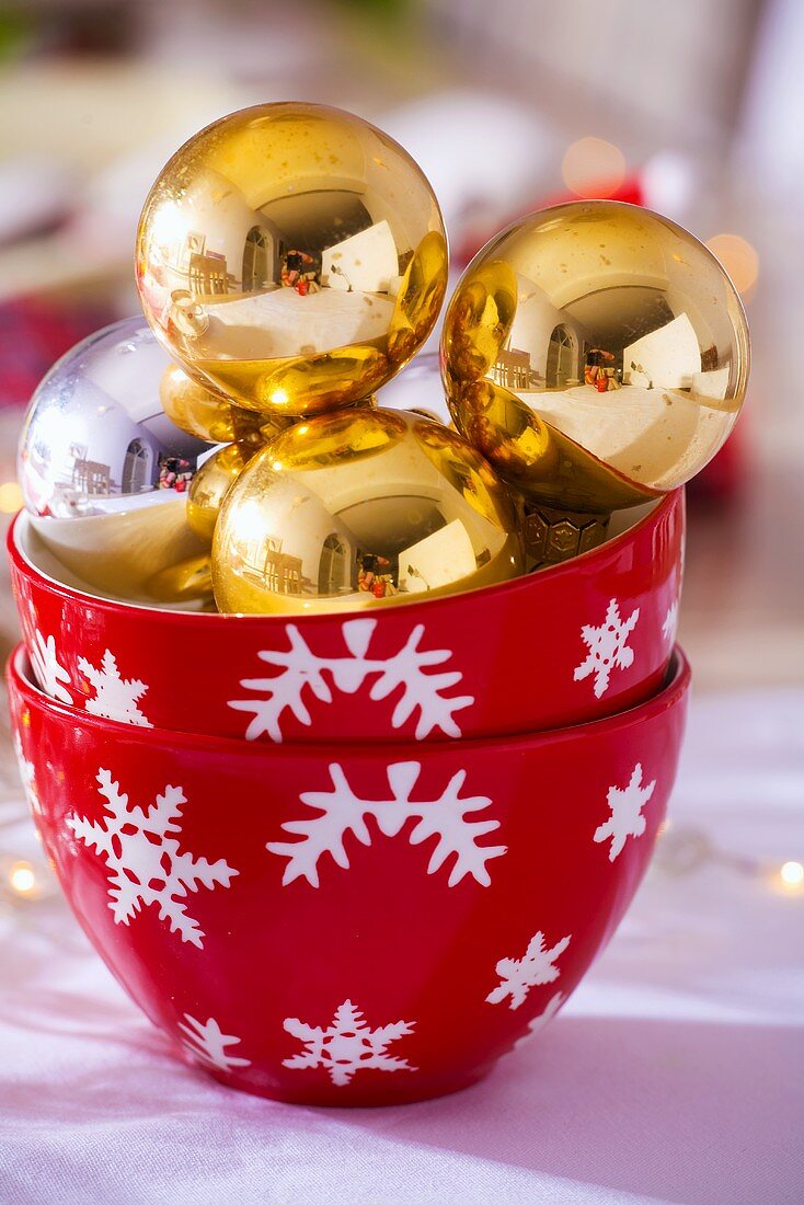 Gold Christmas baubles in two bowls