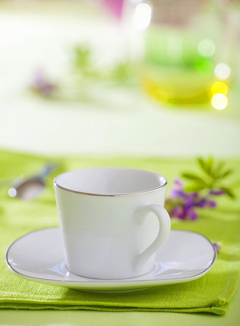 White cup and saucer with silver rim, lavender
