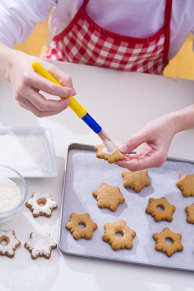 Girl decorating Christmas biscuits