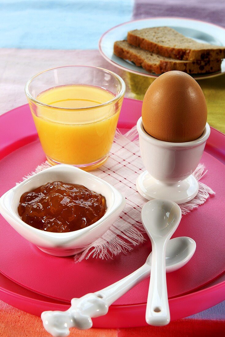 Orange juice, egg and marmalade for breakfast