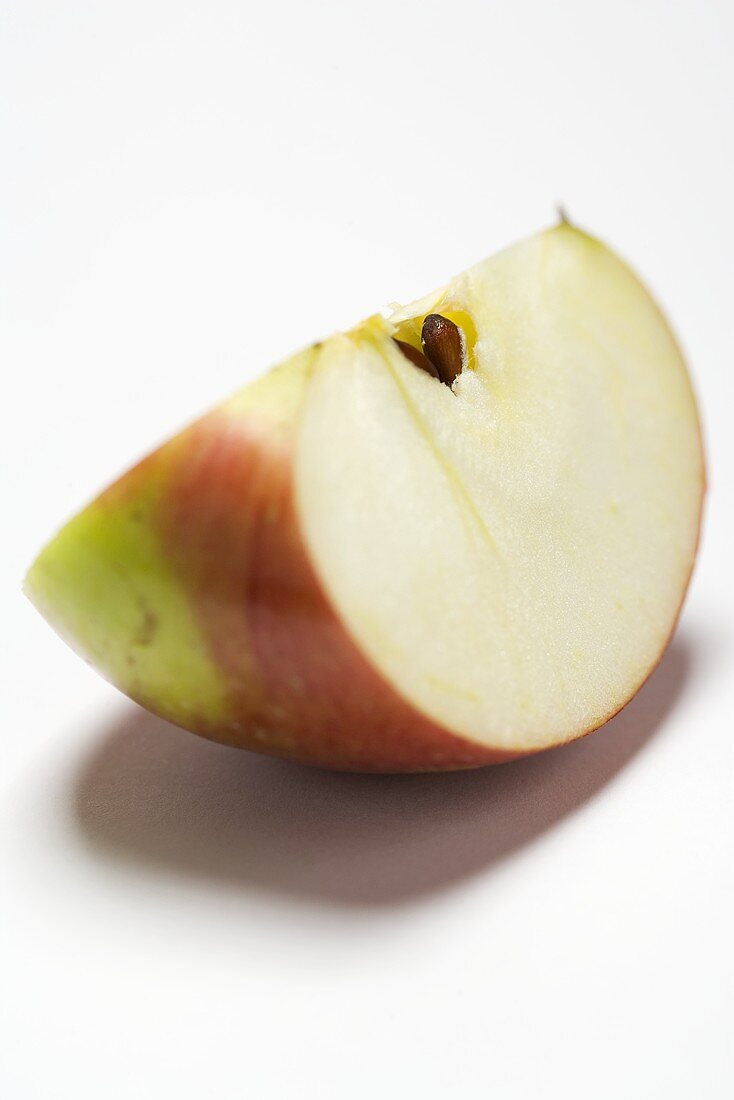A wedge of apple (variety 'Braeburn')