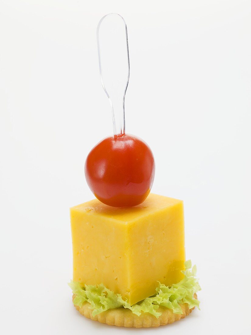 Cheese and cherry tomato on cracker
