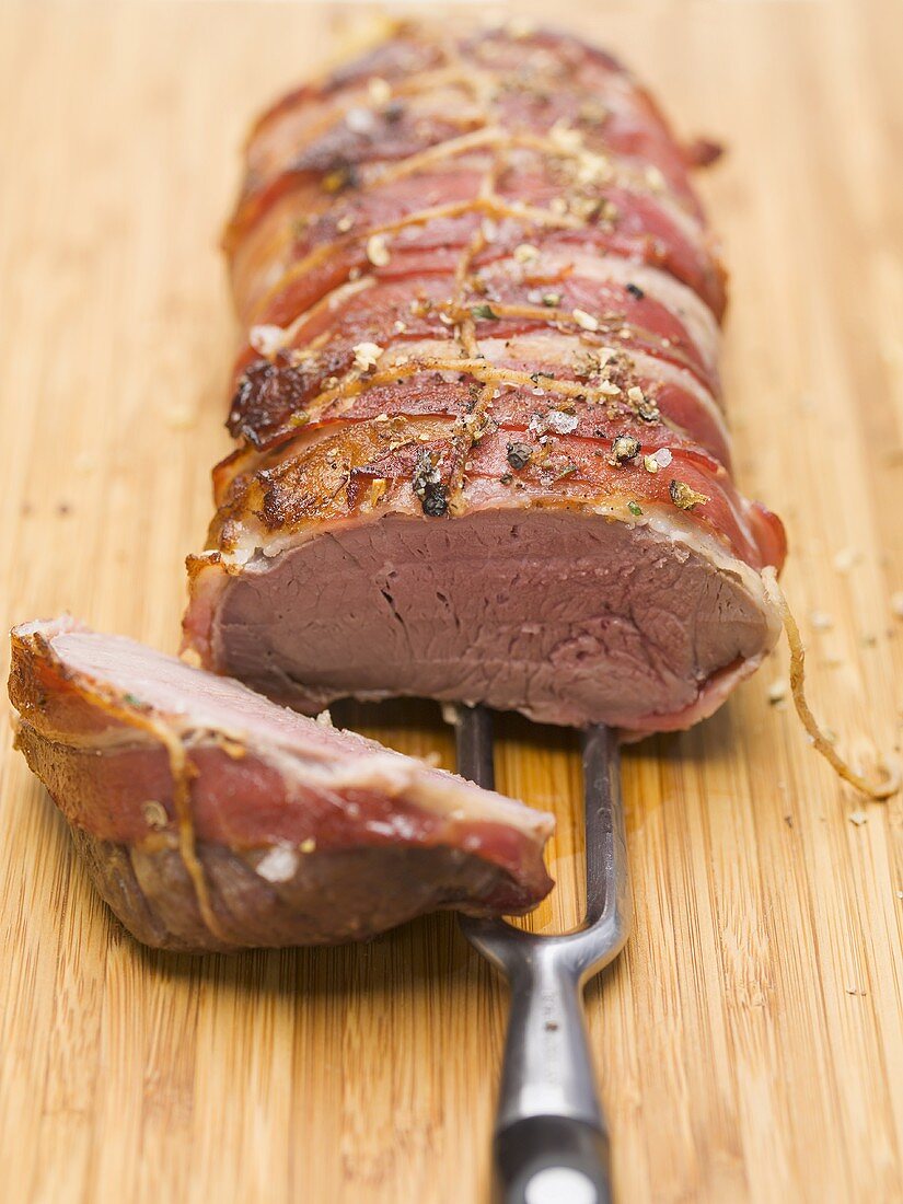 Bacon-wrapped leg of venison